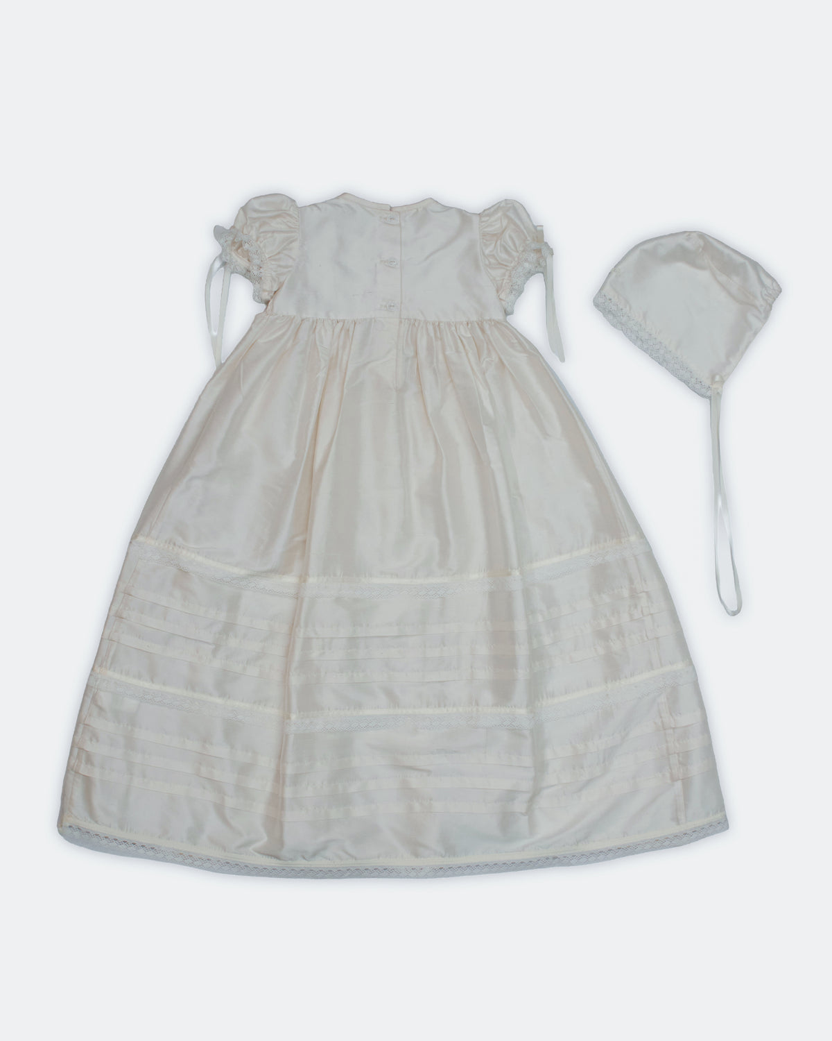 Flat lay back view of white ivory silk christening gown set — Josephine Gown Set by Bonbon Rue