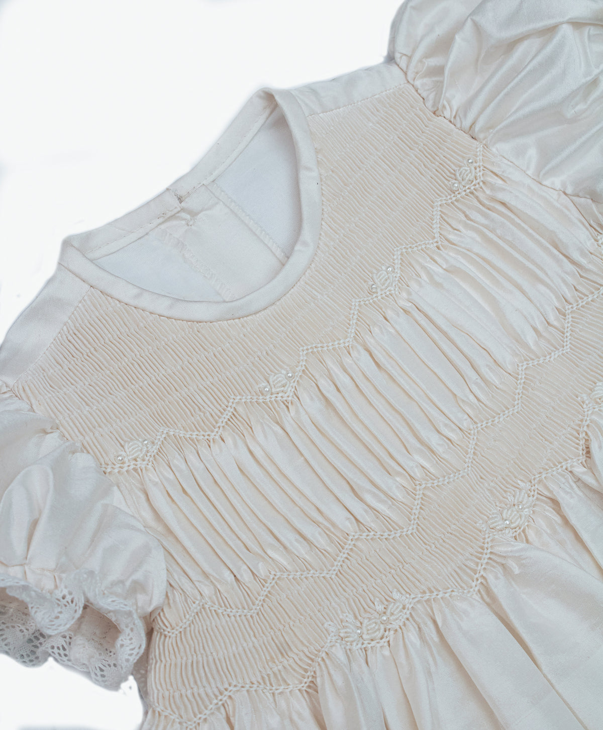 Detail of horizontal tucks and dupioni silk texture on white ivory baby christening gown — Josephine Gown Set by Bonbon Rue